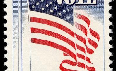 A 5 cent postage stamp with the American flag waving. In all-caps block lettering, it read "Register - Vote"