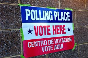 A red white and blue sign reads: "Polling Place - Vote Here"